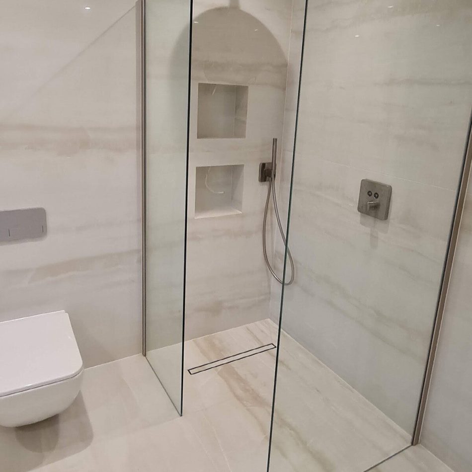 Frameless glass shower enclosure installed by Croydon-based construction company Art & Build Ltd